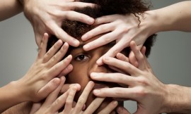 Black male hidden by hands